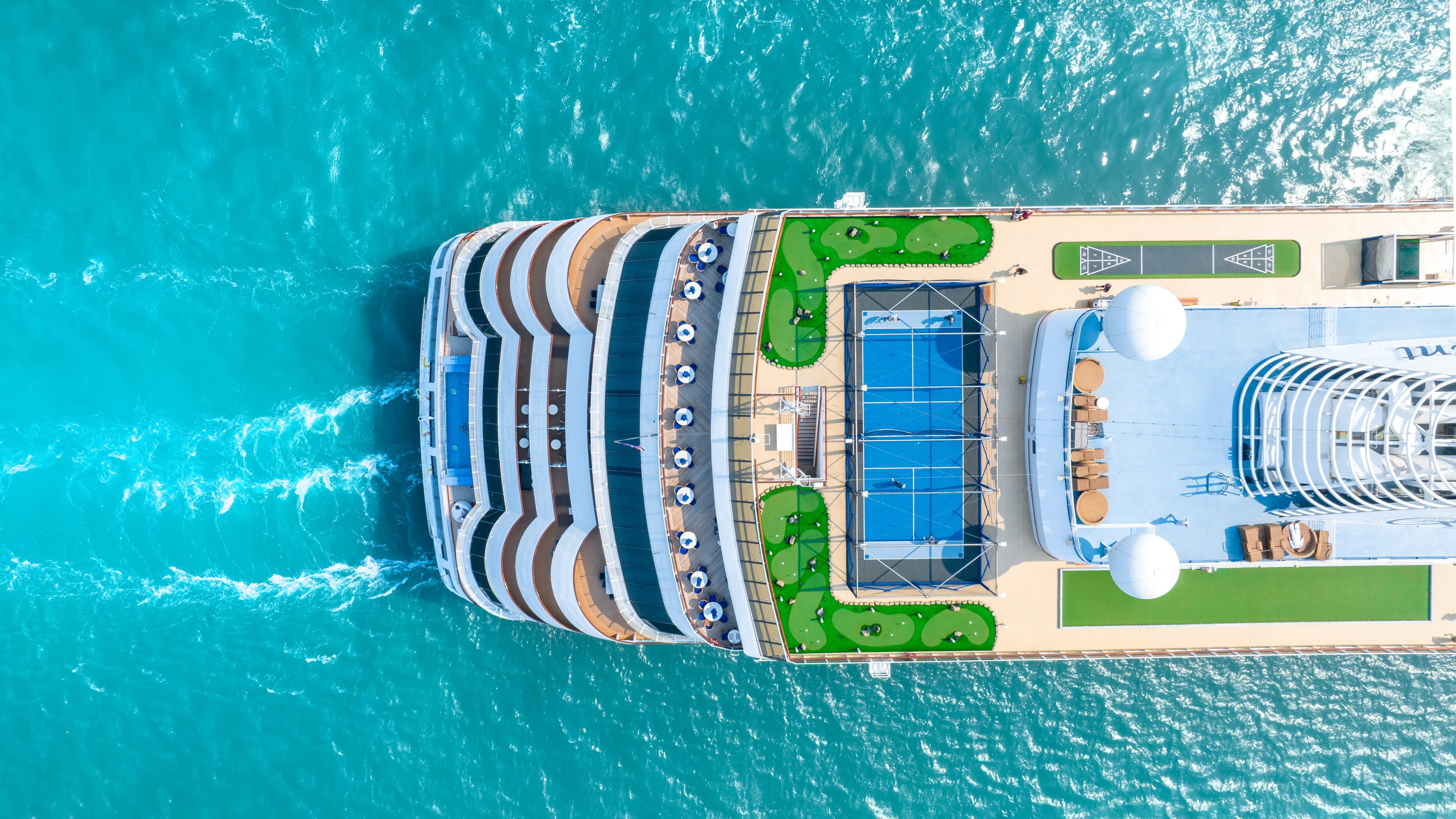 Luxury cruise ship sailing on calm ocean waters at sunset